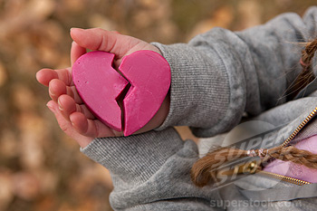 Girl holding broken heart